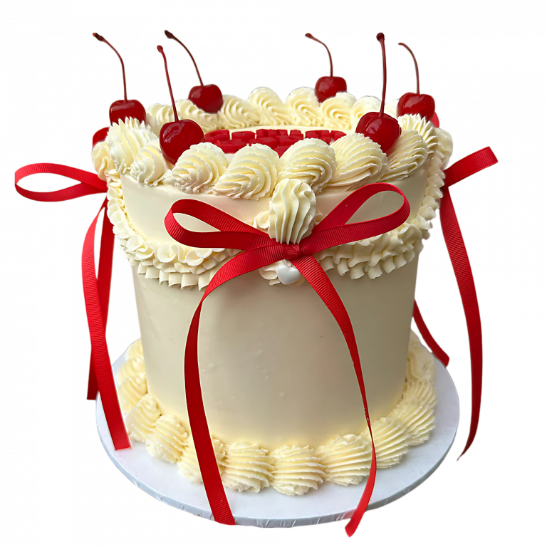 Cremefarbene Vintage-Torte mit roten Schleifen und Kirschen